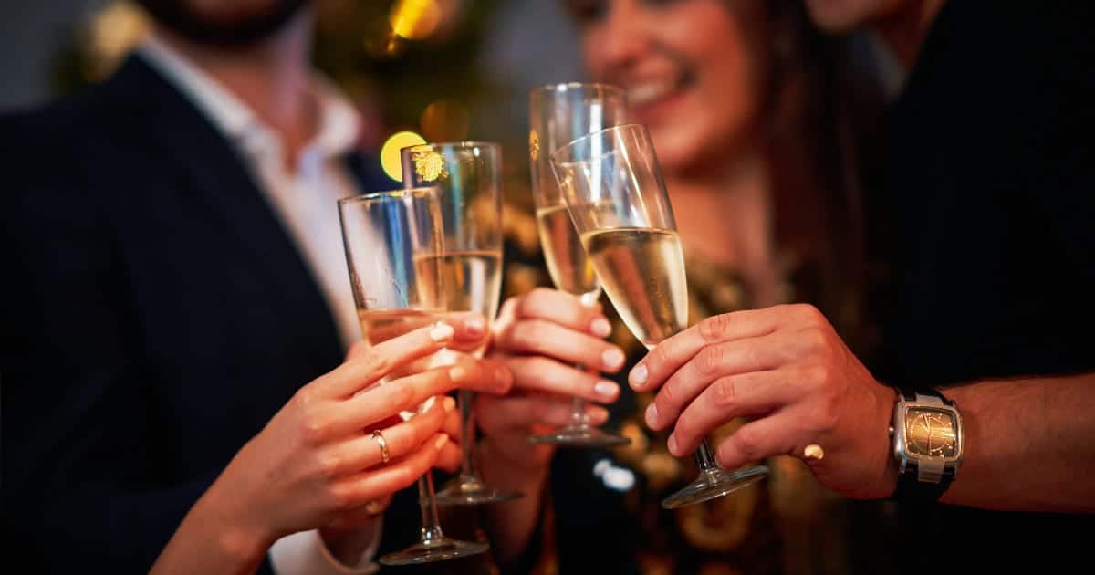 9 Fab New Year’s Eve Dress Styles for Under $50 67 Friends at New Year's Eve party toasting with champagne.
