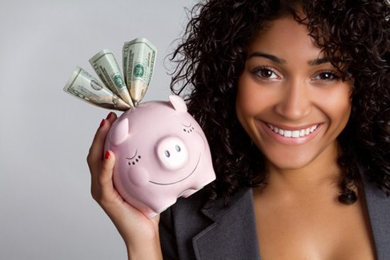 40 Simple Life Hacks to Save Money Fast 14 Adult smiles while holding piggy bank showing she knows how to save money.
