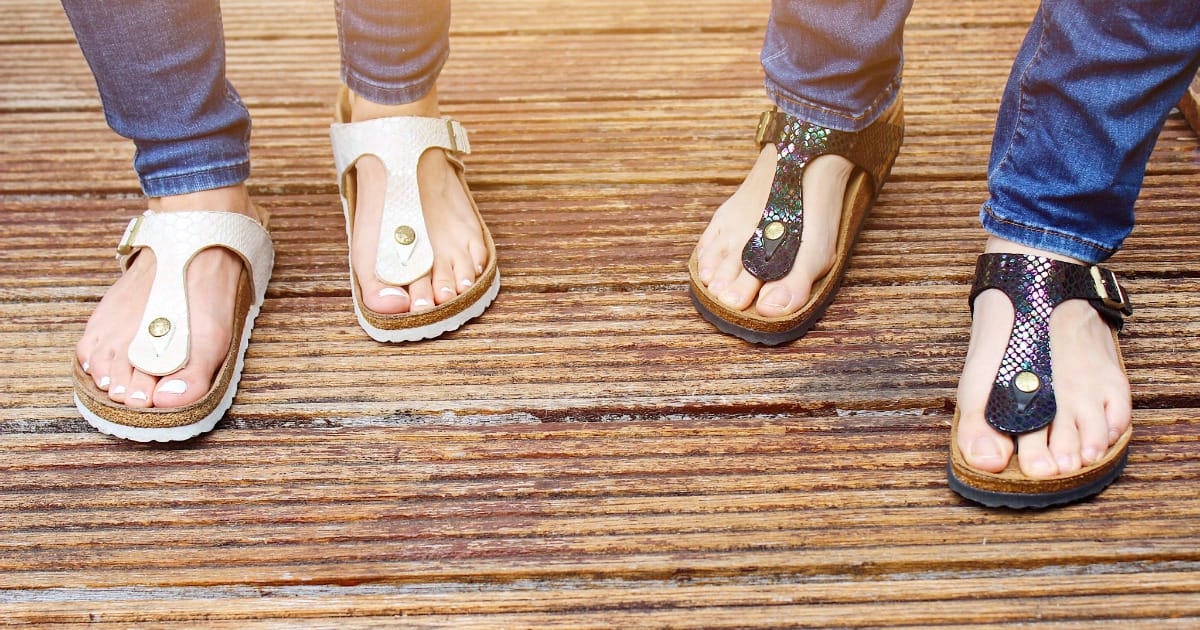 Close up view of women's feet wearing Birkenstock sandals.