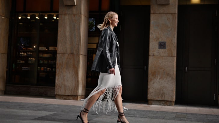 Leather Clothes are Trending: Here's How to Wear Them 78 Woman wearing leather blazer walks down street.