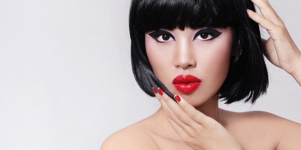 Woman with cat-eye makeup and bold red lips