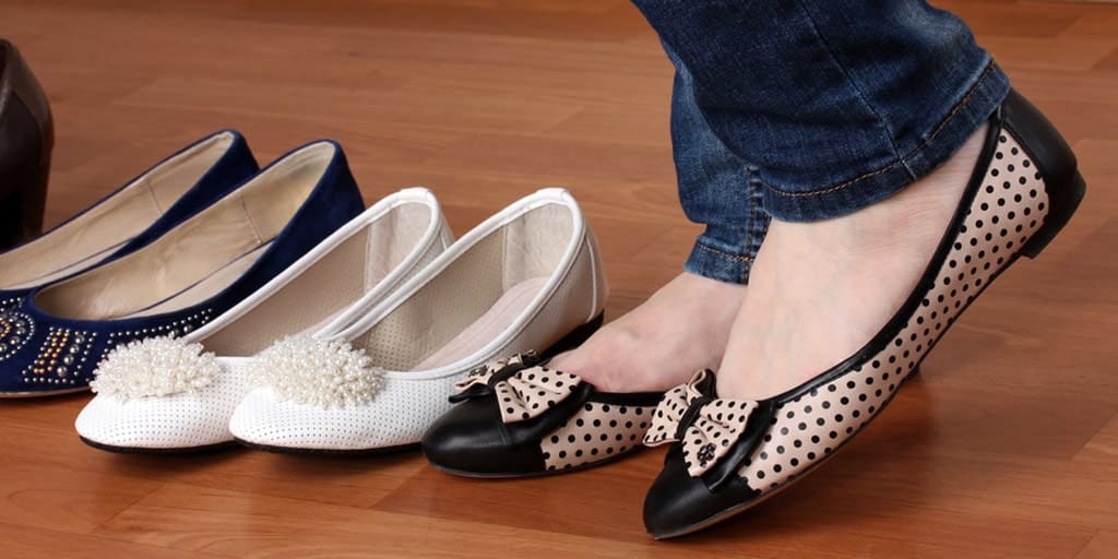 Close up of woman trying on flat shoes
