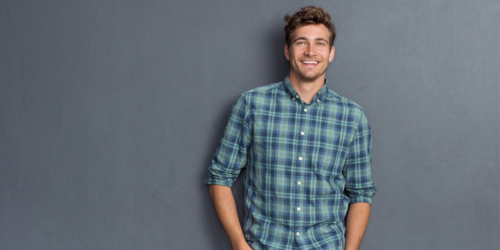 Smiling man wearing plaid shirt