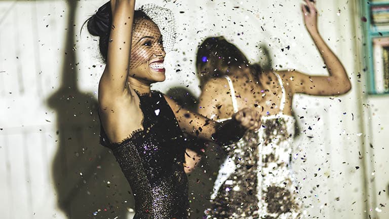 Woman wearing summer party dresses, dancing.