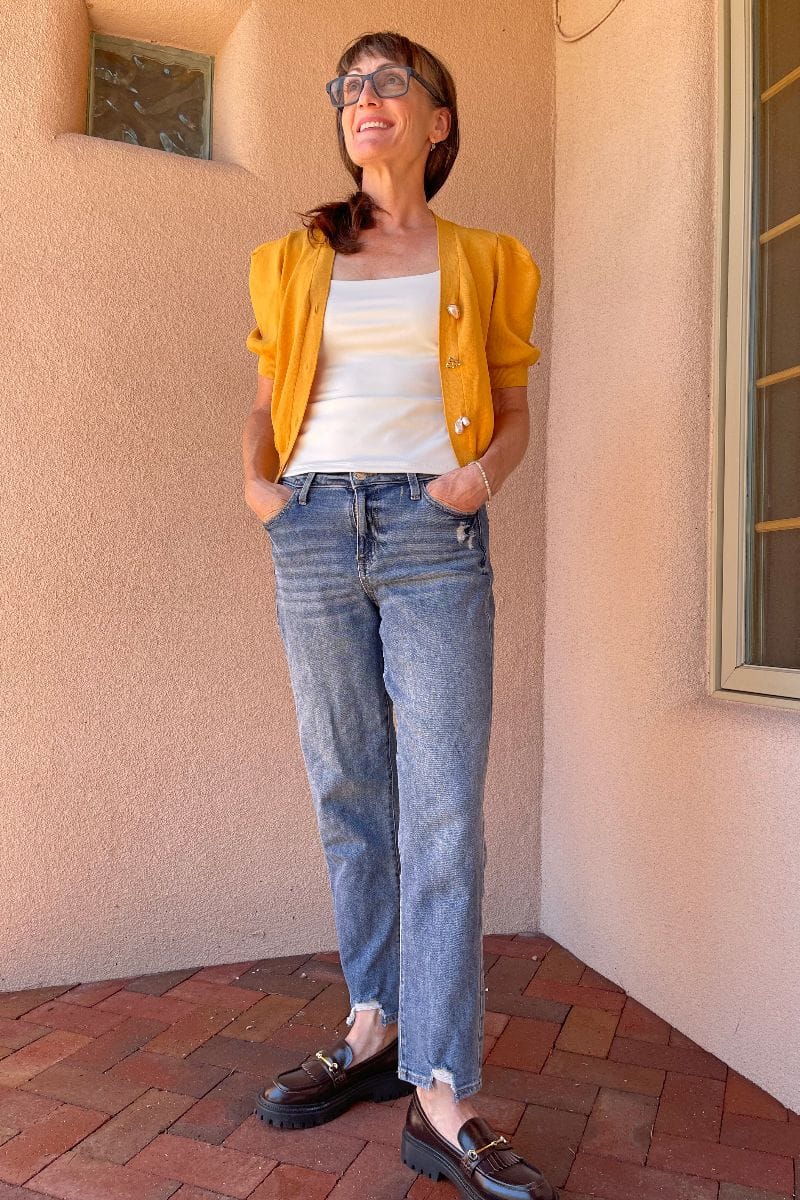 How to Wear Chunky Loafers After 40 6 Catherine Brock wearing chunky loafers with cardigan and mom jeans.