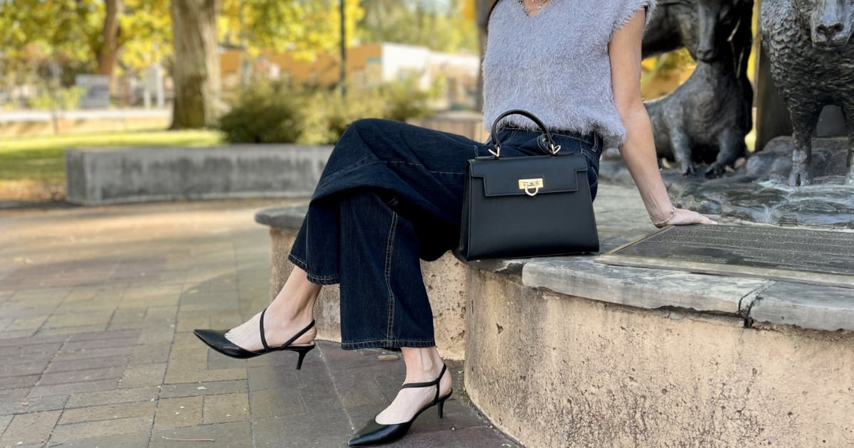 The Top Handle Bag: Where to Get This Chic Accessory for Less 74 Levantine Layla bag on curb next to stylish woman sitting outside.