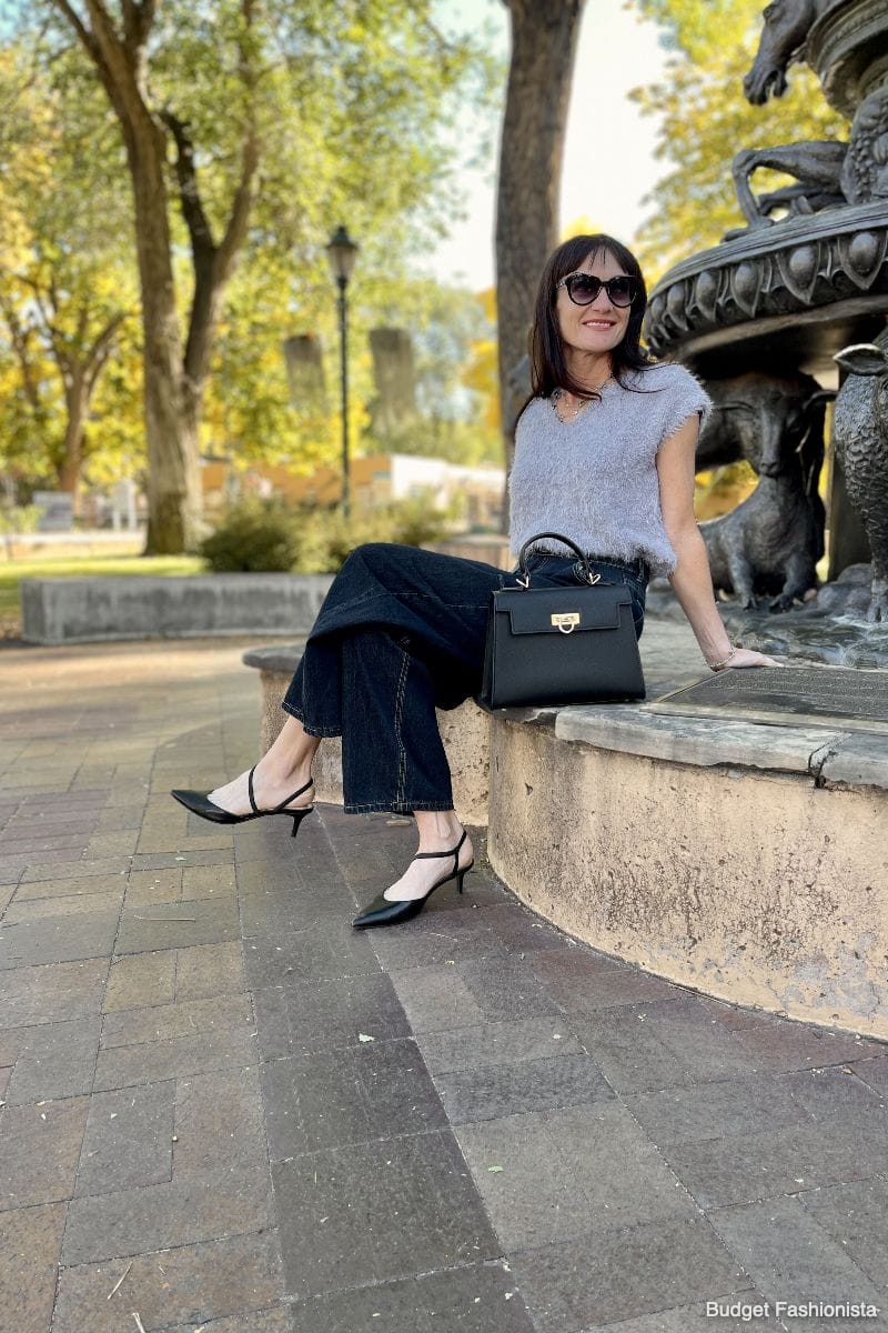 The Top Handle Bag: Where to Get This Chic Accessory for Less 3 Levantine Layla bag on curb next to stylish woman sitting outside.