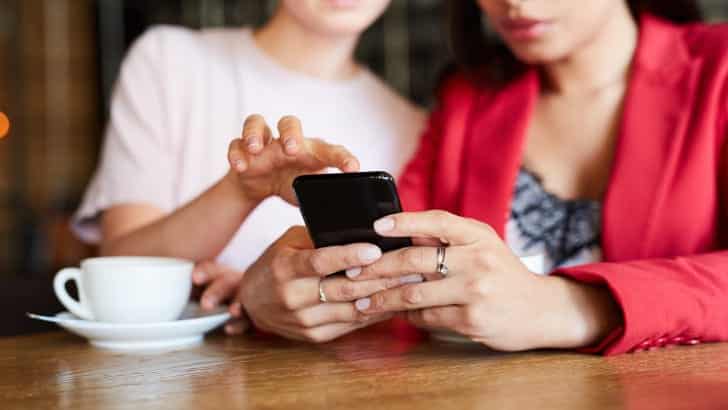 Preview: Top Amazon Prime Day Deals 76 Two women shop Amazon Prime Day deals on a smartphone.