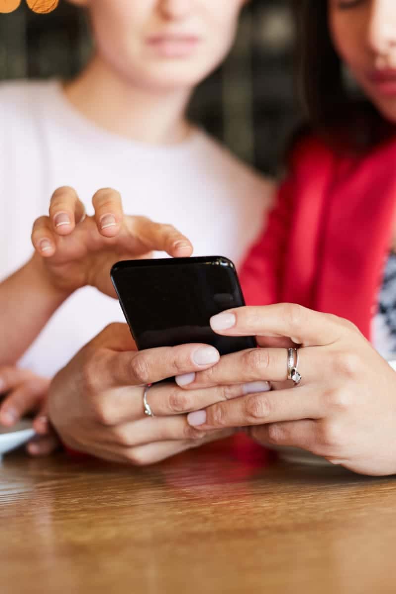 Preview: Top Amazon Prime Day Deals 30 Two women shop Amazon Prime Day deals on a smartphone.