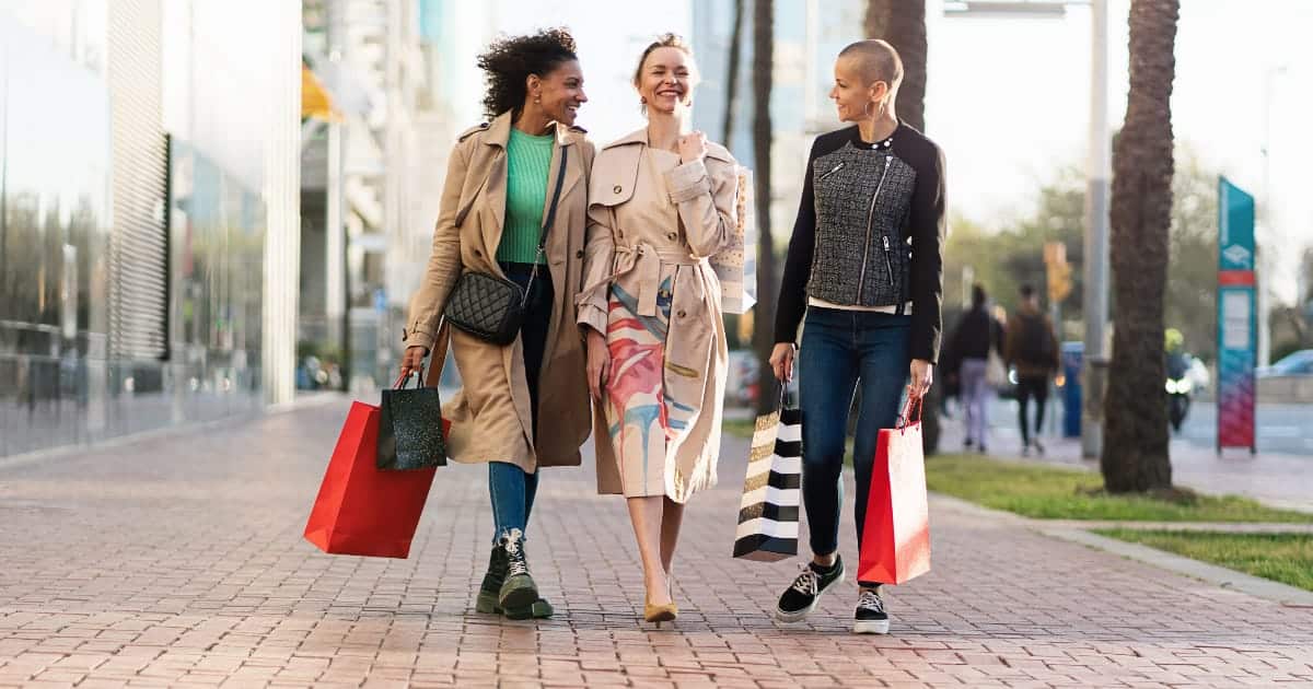 How to: Street Style for Women 71 Three women wearing street style fashion holding shopping bags outside.