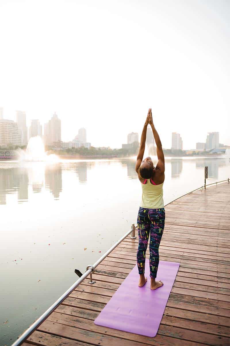 Best Women's Underwear Brands for Wherever Life Takes You 2 Woman doing yoga at park to represent working out.