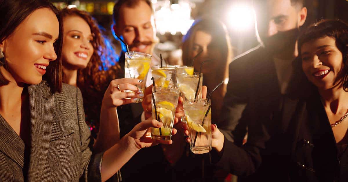 Expert Advice: What to Wear to an Office Holiday Party 61 Group of coworkers drinking together at holiday party.
