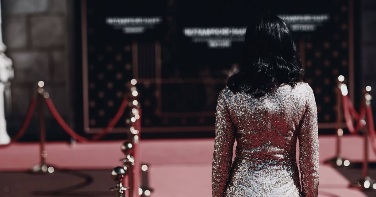 Sneak Peek: 6 Red Carpet Fashion Trends Celebs Will Wear in 2024 55 Low-saturation image of woman walking down a red carpet in a sequin dress.