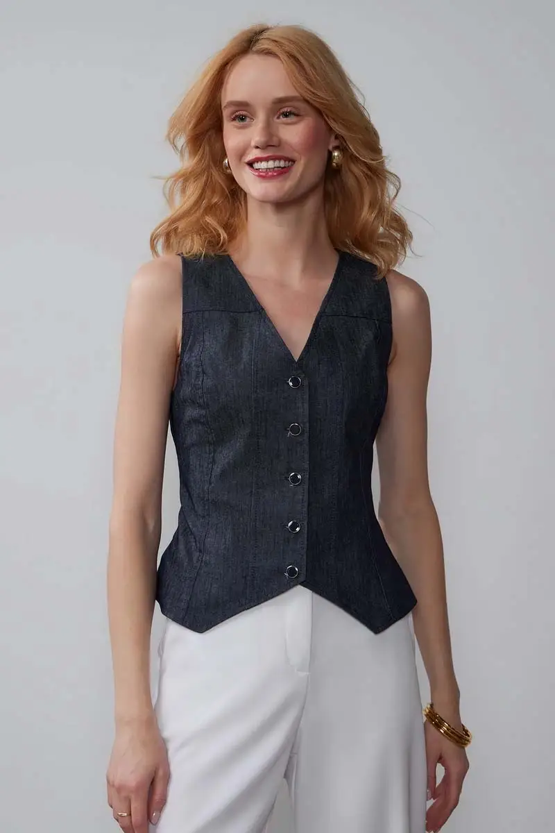Spring 2024 Fashion Trends: 36 Trendy, Affordable Pieces to Wear Now 6 Model wears denim vest with white pants.