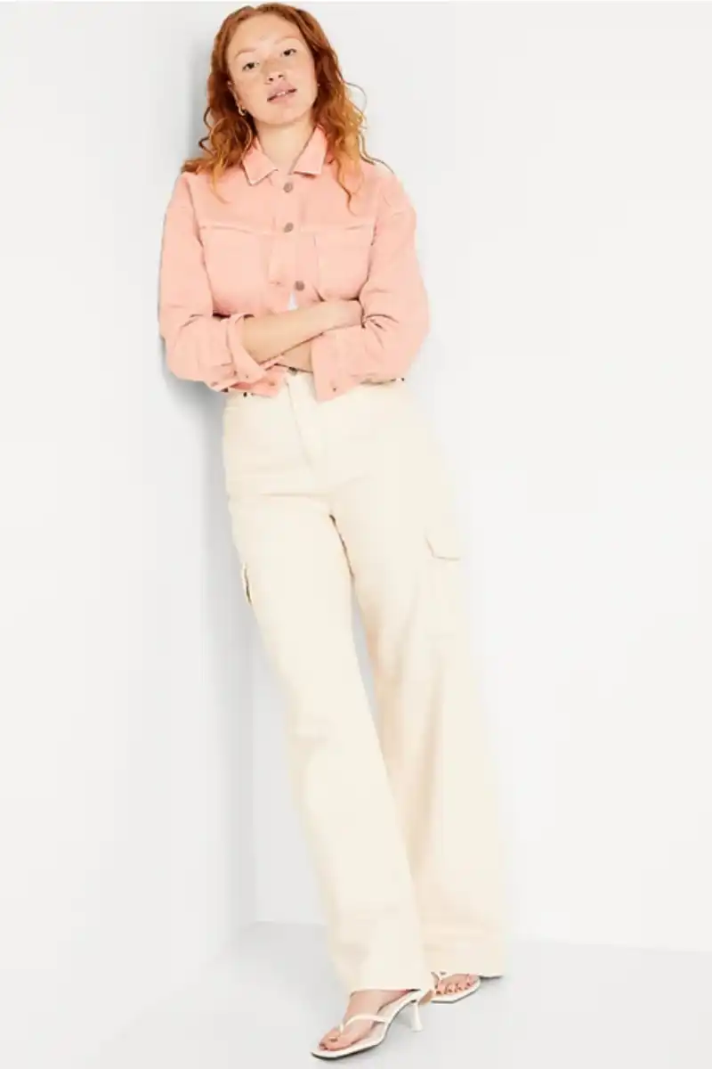 How to Wear the Color Peach 21 Model wearing peach cropped denim jacket against white background.