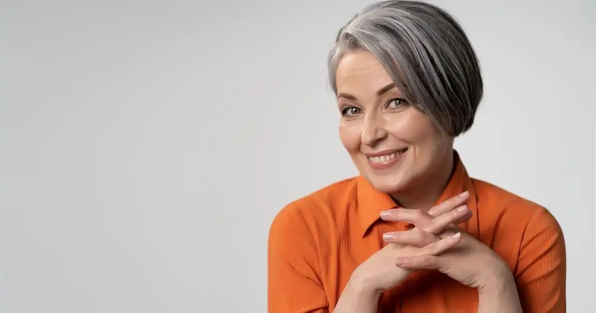 Gut Instincts: How to Unlock Radiant Skin from the Inside Out 37 Smiling older woman wearing orange sweater.