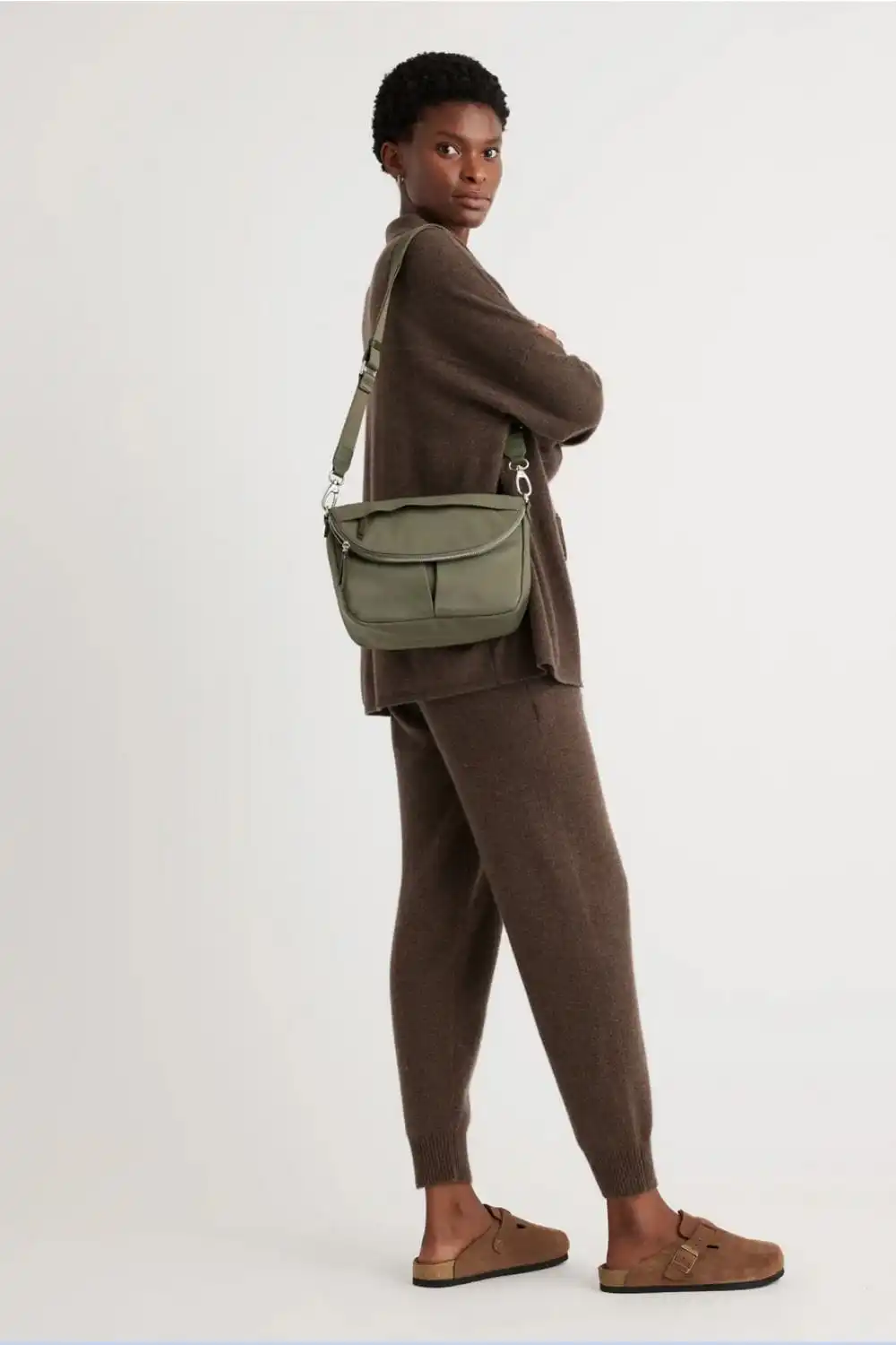 6 Summer 2024 Bag Trends to Try Now 5 Model wears green crossbody bag.