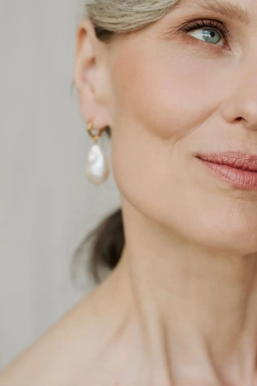 8 Signature Accessory Ideas for the 40+ Fashionista 2 Close-up of older woman wearing pearl earrings.