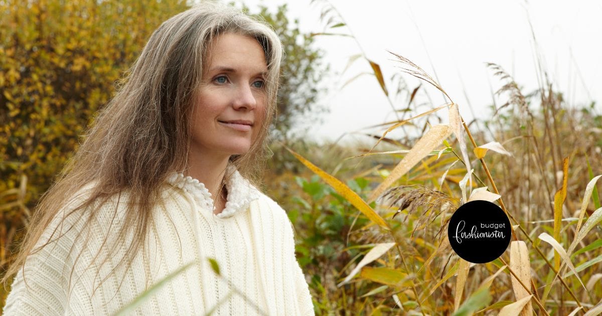 6 Fall Knits Inspired by Gigi Hadid's Instagram 25 Mature woman wearing sweater outside near yellow and green foliage.