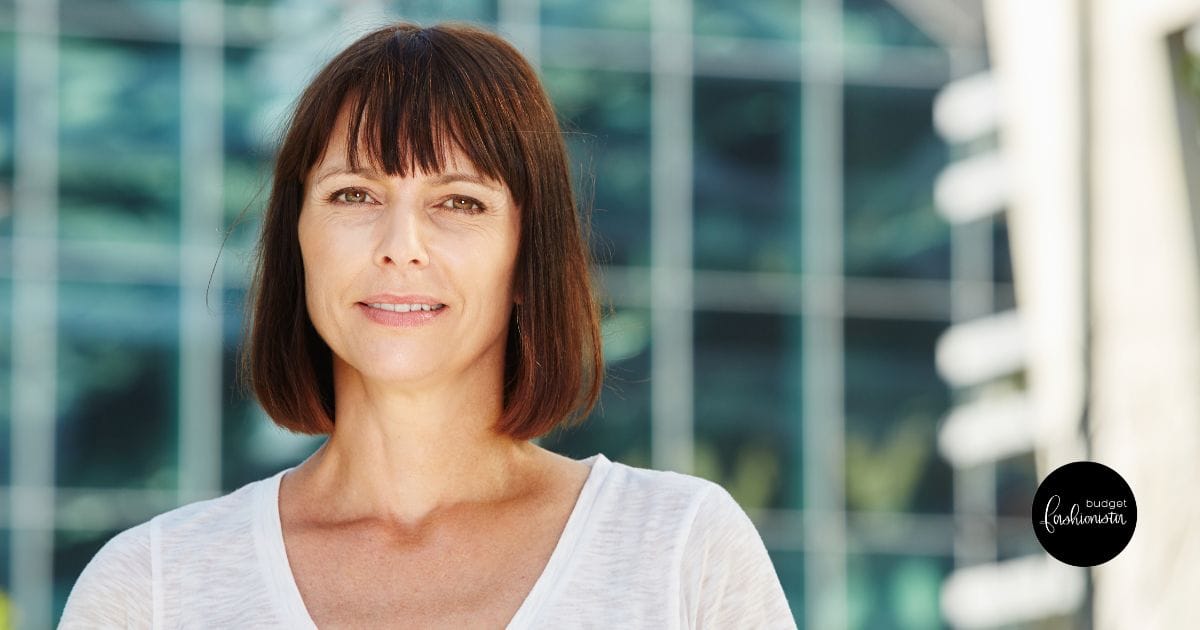 6 Small Style Skills to Defeat Fashion Envy for Good 26 Woman with bob hair style and white top stands outside.