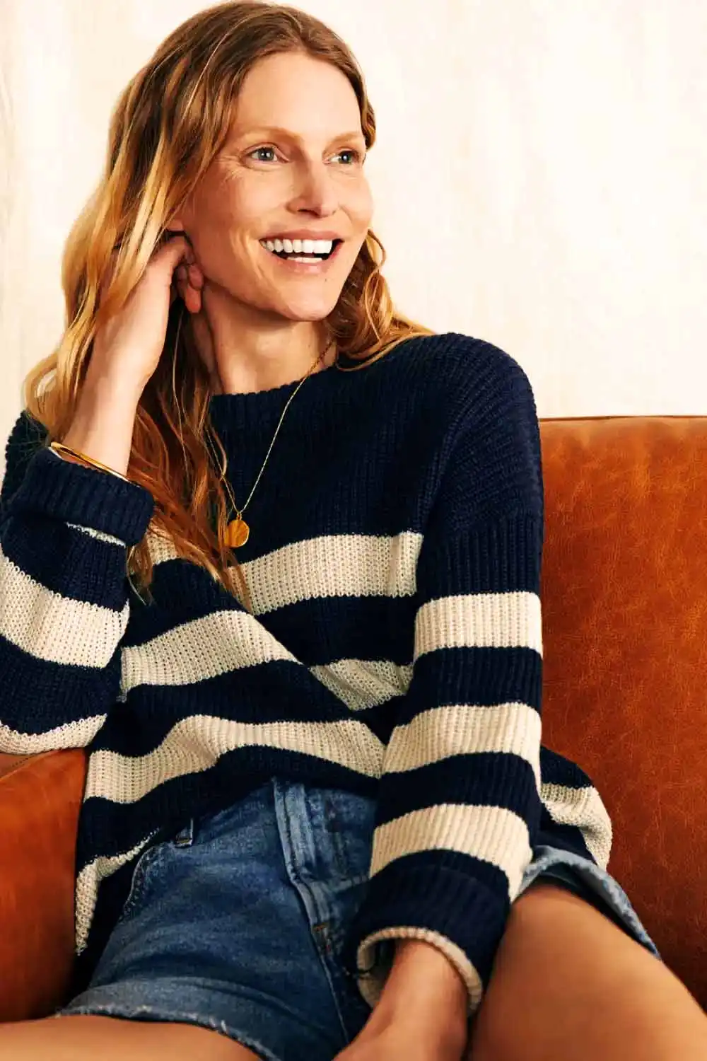 6 Fall Knits Inspired by Gigi Hadid's Instagram 4 Smiling woman wearing striped crew neck sweater.