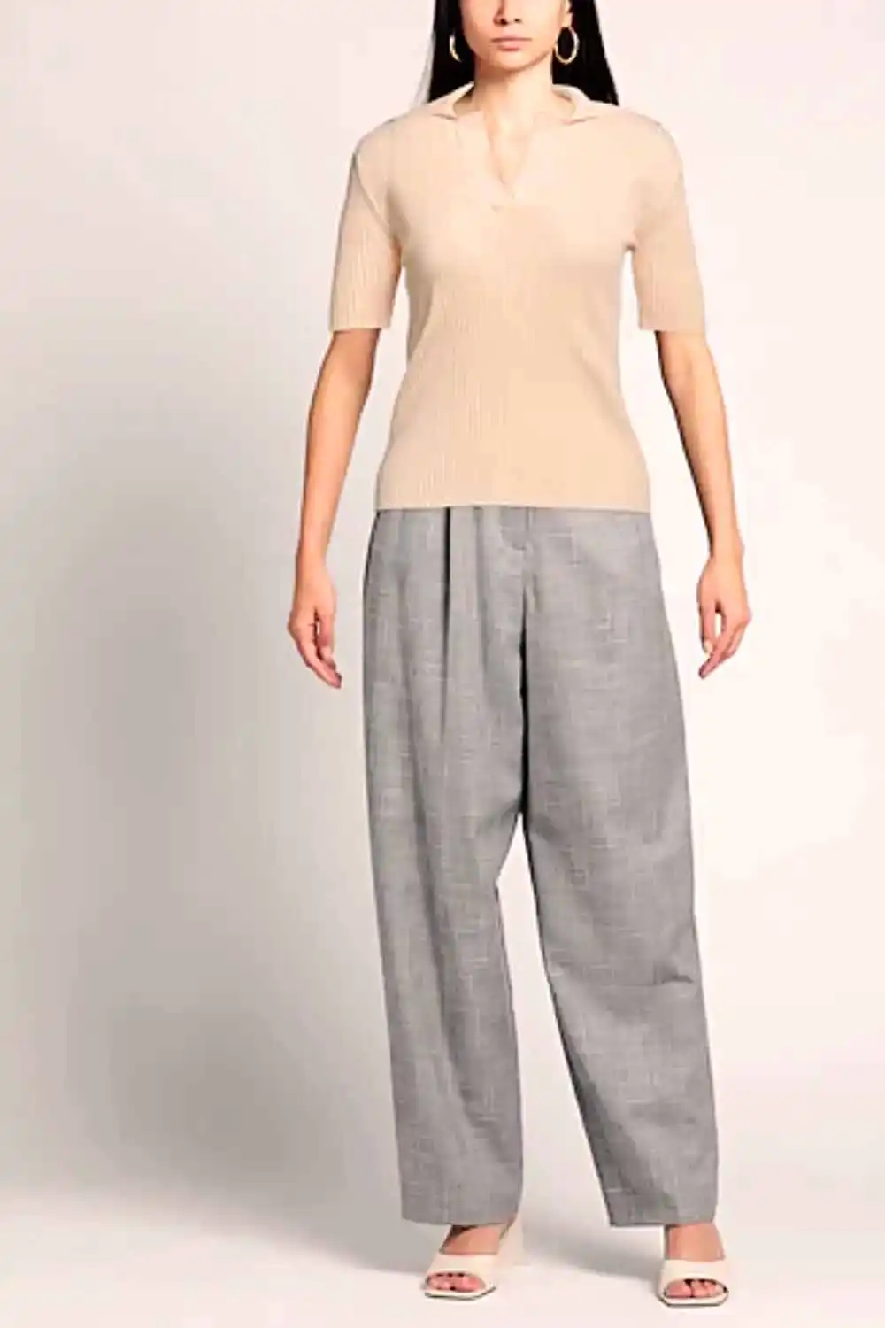 6 Fall Knits Inspired by Gigi Hadid's Instagram 3 Model wearing short-sleeved, collared sweater with baggy pants.