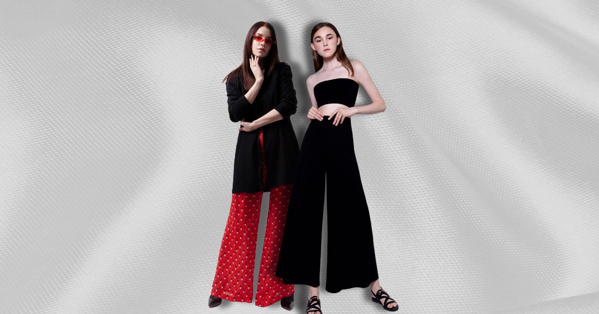 How to Wear Wide-Leg Pants Now 21 Two women wearing wide-legged pants against a textured background.