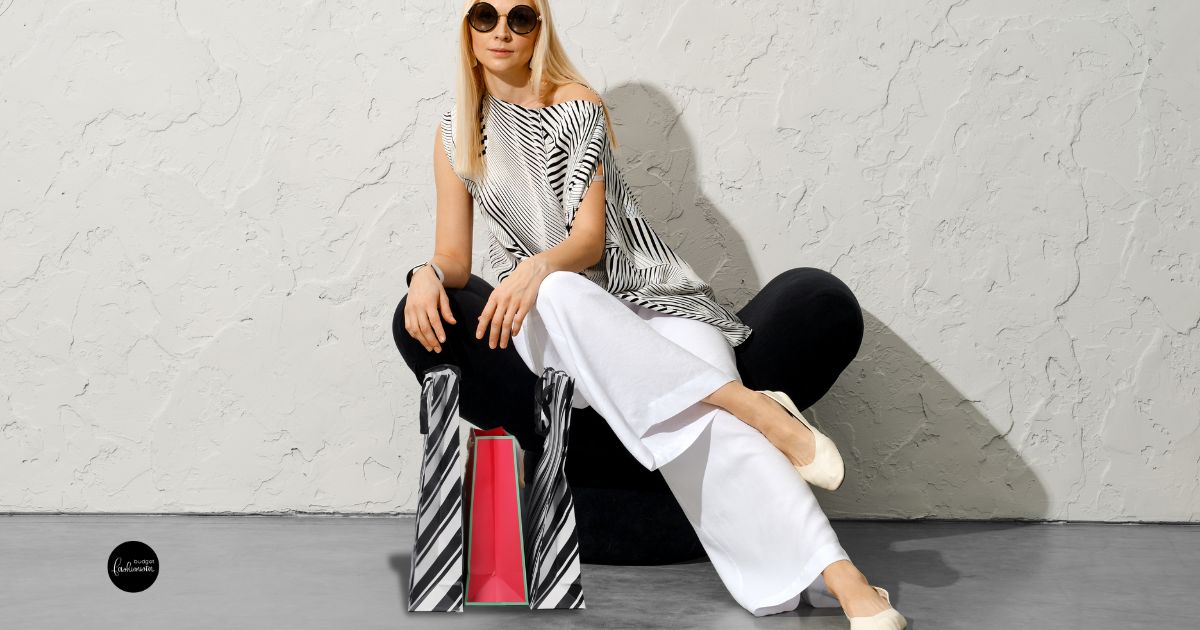 Where to Buy Wide-Leg Pants 20 Woman sitting wearing wide-legged pants with a striped bag.